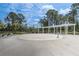 Lounge area with pergola at community pool, surrounded by tall trees and lush landscaping at 15378 Gilligan Ct, Winter Garden, FL 34787