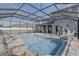 Screened-in pool and spa with a water slide and outdoor seating area at 15378 Gilligan Ct, Winter Garden, FL 34787