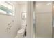 Efficient bathroom with a toilet and shower, showcasing accessibility features like a grab bar at 1548 Challenger Ave, Davenport, FL 33897