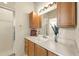 Well-lit bathroom featuring spacious vanity, overhead lighting, and glass-enclosed shower at 1548 Challenger Ave, Davenport, FL 33897