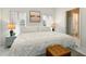 Cozy bedroom with a large bed, natural light from shuttered windows and decorative ottoman at 1548 Challenger Ave, Davenport, FL 33897