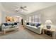 Bright living room featuring plush sofas and a view to the connected dining area at 1548 Challenger Ave, Davenport, FL 33897