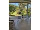 Enclosed patio featuring neutral tile flooring, outdoor chairs, and a lovely backyard view at 1548 Challenger Ave, Davenport, FL 33897