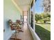 Enclosed patio with tile flooring featuring two bar stools and an exterior view of the yard at 1548 Challenger Ave, Davenport, FL 33897