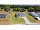Real estate picture features a white single-Gathering home with a gray roof and large manicured lot at 16655 Sw 43Dr Terrrace Rd, Ocala, FL 34473