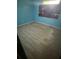 Bedroom with light blue walls and updated floors at 1675 Louis Dr, Kissimmee, FL 34758