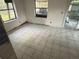 View of an empty room with white tile flooring at 1675 Louis Dr, Kissimmee, FL 34758