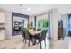 Dining area features a modern table with six chairs, a large mirror, and sliding glass doors to the outdoors at 1830 Escobar Ave, Deltona, FL 32725