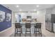 Modern kitchen with a granite island, seating for three, stainless steel appliances, and white cabinetry at 1830 Escobar Ave, Deltona, FL 32725