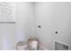 Bright laundry area features a convenient utility sink and laundry baskets for added storage at 1830 Escobar Ave, Deltona, FL 32725