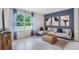 Comfortable living room with a large window with outdoor view, blue curtains, stylish decor, and neutral color palette at 1830 Escobar Ave, Deltona, FL 32725