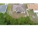 Aerial shot of backyard featuring trees and home including the screened in porch at 2104 E Parkton Dr, Deltona, FL 32725
