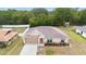Aerial view of home with well-maintained landscaping, lawn and fenced yard at 2104 E Parkton Dr, Deltona, FL 32725