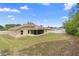 Expansive backyard showcasing screened lanai and ample green space at 2104 E Parkton Dr, Deltona, FL 32725