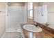 Bright bathroom with a large vanity, step-in shower, and window for natural light at 2104 E Parkton Dr, Deltona, FL 32725