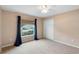 Neutral bedroom features large window, ceiling fan and a spacious closet at 2104 E Parkton Dr, Deltona, FL 32725