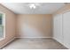 Comfortable bedroom with natural lighting, ceiling fan and spacious closet at 2104 E Parkton Dr, Deltona, FL 32725