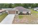 Charming single-story home with a well-manicured lawn and a two-car garage at 2104 E Parkton Dr, Deltona, FL 32725