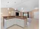 Open-concept kitchen featuring a breakfast bar that connects to the living space, ideal for entertaining at 2104 E Parkton Dr, Deltona, FL 32725
