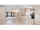 Bright open-concept kitchen featuring modern appliances, a breakfast bar, and seamless flow into the living area at 2104 E Parkton Dr, Deltona, FL 32725
