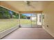 Screened lanai features large back yard and ceiling fan at 2104 E Parkton Dr, Deltona, FL 32725