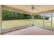 Screened lanai featuring large back yard views and ceiling fan at 2104 E Parkton Dr, Deltona, FL 32725
