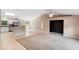 Open-concept living space with neutral colors and view to kitchen with stainless appliances at 2104 E Parkton Dr, Deltona, FL 32725