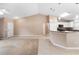 Bright open-concept living area connecting the kitchen, all with a neutral color palette at 2104 E Parkton Dr, Deltona, FL 32725
