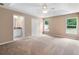 Spacious main bedroom boasts a tray ceiling, ceiling fan, dual windows and an ensuite bathroom at 2104 E Parkton Dr, Deltona, FL 32725