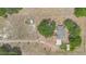 A top-down aerial view of the property highlighting the home's layout, surrounding trees, and expansive lot at 22619 State Road 44, Eustis, FL 32736