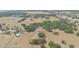 Extensive aerial view shows many trees, outbuildings, pastures, and the subject property at 22619 State Road 44, Eustis, FL 32736
