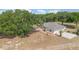 Aerial view showcasing the home's spacious yard, patio area, and surrounding mature trees at 22619 State Road 44, Eustis, FL 32736