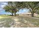 Expansive backyard featuring lush greenery and mature trees, providing a serene and private outdoor space at 22619 State Road 44, Eustis, FL 32736
