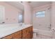 Bathroom featuring a vanity, toilet and shower-tub combo with window at 22619 State Road 44, Eustis, FL 32736