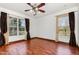 Bedroom with hardwood floors, ceiling fan and scenic outdoor views at 22619 State Road 44, Eustis, FL 32736