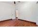 Bedroom with wood-look floors, neutral walls, and white doors at 22619 State Road 44, Eustis, FL 32736