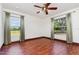 Bright bedroom with hardwood floors, ceiling fan and expansive outdoor views at 22619 State Road 44, Eustis, FL 32736
