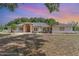 Inviting single-story home featuring a symmetrical facade, arched entryway, and well-maintained landscaping at 22619 State Road 44, Eustis, FL 32736