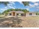 Inviting single-story home featuring a symmetrical facade, arched entryway, and well-maintained landscaping at 22619 State Road 44, Eustis, FL 32736