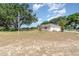Spacious front yard featuring a home and mature landscaping at 22619 State Road 44, Eustis, FL 32736
