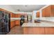 Well-equipped kitchen with granite countertops, wood cabinets, and modern appliances at 22619 State Road 44, Eustis, FL 32736