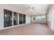 Covered lanai featuring multiple ceiling fans and sliding glass doors at 22619 State Road 44, Eustis, FL 32736