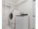 Laundry room with washer, dryer, and wire shelving for storage at 22619 State Road 44, Eustis, FL 32736