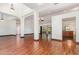 Open-concept living area with hardwood floors, decorative columns, and natural light at 22619 State Road 44, Eustis, FL 32736