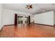 Open living space with hardwood floors, sliding glass doors, and a decorative ceiling fan at 22619 State Road 44, Eustis, FL 32736