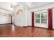 Bright living room with hardwood floors, large windows, and an elegant chandelier lighting at 22619 State Road 44, Eustis, FL 32736