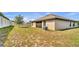 View of the backyard featuring a partial fence and green space, perfect for outdoor activities at 228 Bergamot Loop, Davenport, FL 33837