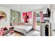 This bedroom features a bed, decor, and natural light from a window at 228 Bergamot Loop, Davenport, FL 33837