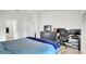 Bedroom features tile flooring, an office space, and blue bedding at 228 Bergamot Loop, Davenport, FL 33837