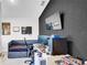 Modern bedroom featuring dark accent wall, a comfortable bed, and desk area at 228 Bergamot Loop, Davenport, FL 33837